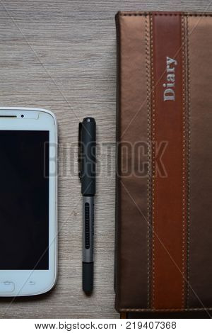 Notepad, pen and phone on the table , for office employee