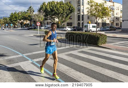MALAGA SPAIN - DECEMBER 10 2017: Athletes run during Zurich Maraton Malaga on the streets of Malaga city Andalusia Spain. More than 3400 marathoners took part in the 8th Malaga Marathon