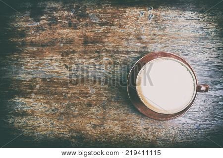 Topdown View Of Cappuccino Coffee On Old Wooden Table With Vintage Effect.