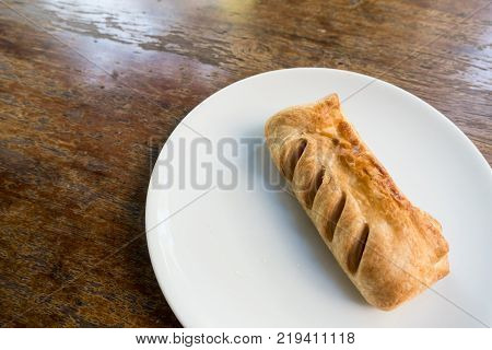 Topdown View Of English Pastry Pie On White Dish On Brown Table.