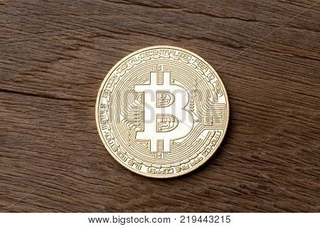 Golden bitcoin on wooden background. High resolution photo.