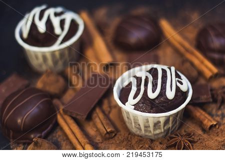 homemade spicy chocolate cupcake sweets and spices mess on the table