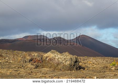 timanfaya national park, Lanzarote, Canary islands, Spain. Red mountains in the distance. Clear blue sky. Red Mountains in focus. Landscape.