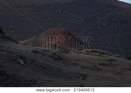 timanfaya national park, Lanzarote, Canary islands, Spain. Red mountains in the distance. Clear blue sky. Red Mountains in focus. Landscape.
