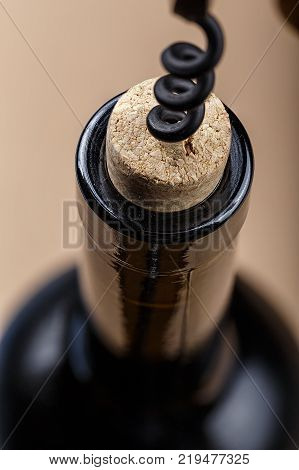 a bottle of wine is opened with a corkscrew a corkscrew is screwed into a bottle stopper