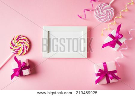 Valentines and birthday card with gift lollipop and poster on pink background. Moke up