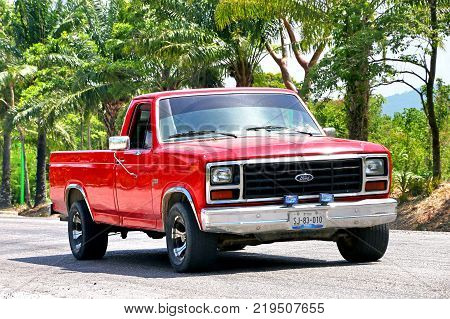 Palenque Mexico - May 22 2017: Red pickup truck Ford F-150 in the town street.