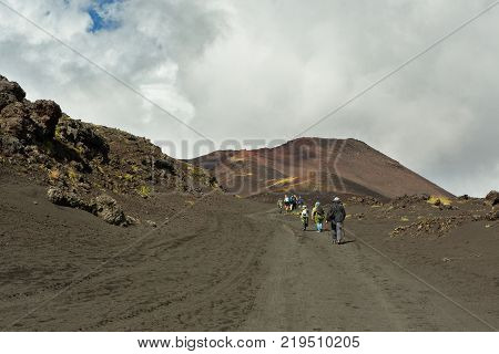 Kamchatka Peninsula, Russia - August 21, 2016: Group of tourists walks on the Lava field at the Tolbachik volcano, after eruption in 2012