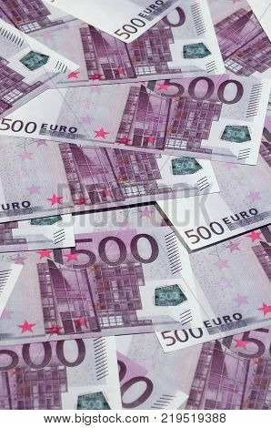 Money background consisting of purple five hundred Euro bills spread across the screen. Symbolic texture photo of wealth