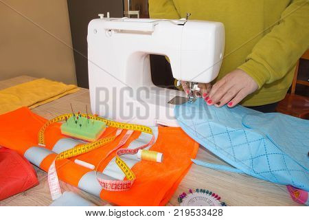 woman hands sewing cloth In Studio. Tailor hands working with scissor and suit textile cloth