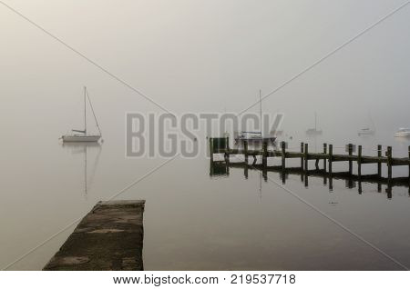 A foggy morning on at Waterhead pier on Windermere in the English Lake District.