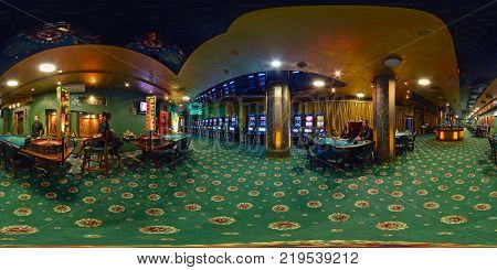MINSK BELARUS - NOVEMBER 8 2011: panorama of interior in luxury casino шт green style with croupier. Full 360 by 180 degree seamless spherical panorama in equirectangular equidistant projection.