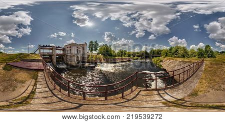 Mini hydro power plant on the lake on a sunny day. Full 360 degree panorama in equirectangular spherical projection