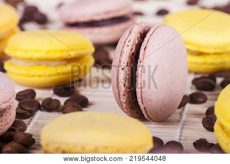 macarons with coffee flavor and coffee beans on white background