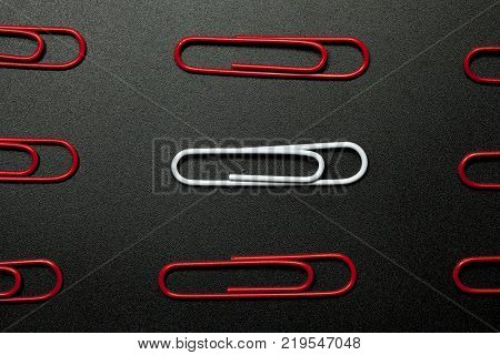 row of paper clip on black background different concept