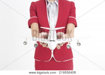 Closeup Of Air Hostess Holding Airplane Model With White Background Woman Stand And Smile At Isolate