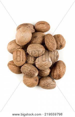 Pile Of Whole Dried Nutmeg Seed For Flavoring