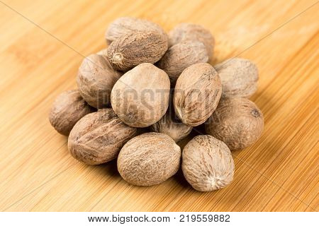 Pile Of Whole Dried Nutmeg Seed For Flavoring