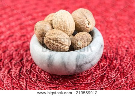 Pile Of Whole Dried Nutmeg Seed For Flavoring