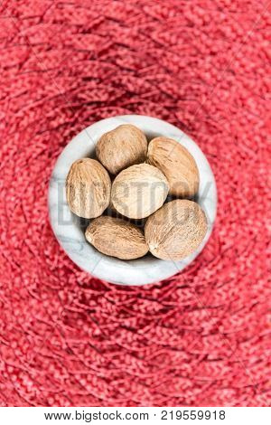 Pile Of Whole Dried Nutmeg Seed For Flavoring