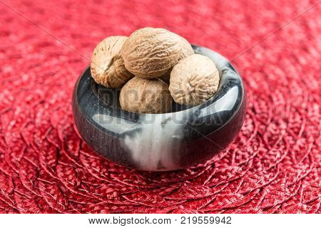 Pile Of Whole Dried Nutmeg Seed For Flavoring