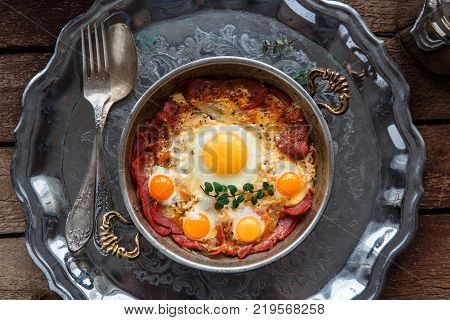 Top view of fried eggs with cured meat, turkish breakfast pastirmali yumurta.
