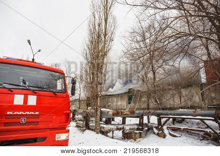 Voronezh, Russia - December 25: Fire in an industrial warehouse on Lantenskaya Street, rubber is burning, lots of smoke and flames, firefighters and MES rescue workers are struggling with a fire