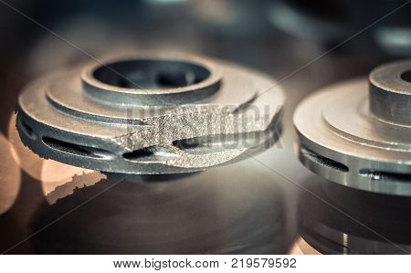 Object printed on metal 3d printer. A model created in a laser sintering machine close-up. DMLS, SLM, SLS technology. Concept of 4.0 industrial revolution. Progressive modern additive technology.