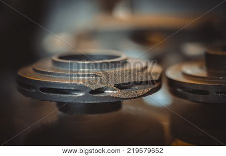 Object printed on metal 3d printer. A model created in a laser sintering machine close-up. DMLS, SLM, SLS technology. Concept of 4.0 industrial revolution. Progressive modern additive technology.