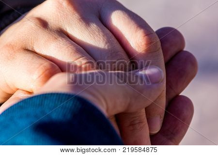 boyfriend and girlfriend holding hands together while they are walking