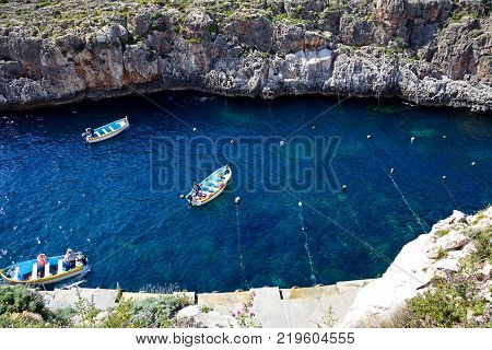 BLUE GROTTO, MALTA - APRIL 1, 2017 - Elevated view of traditional Dghajsa water taxi boats at the departure point in the bay Blue Grotto Malta Europe, April 1, 2017.