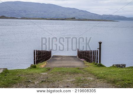 The rotten pier at Craignish point with the Sound of Jura in the background, Scotland
