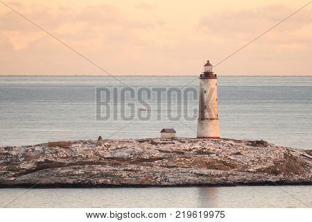 Sea view to the small Torungen lighthouse a cold colorful winter evening