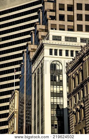 modern traditional architecture tall buildings in city granite brick glass in afternoon sunlight