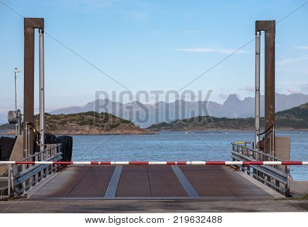 ferry gate closed with turnpike on sea and mountains horizon background