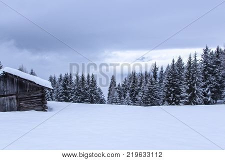 snowy and foggy montain wooden cabin landscape