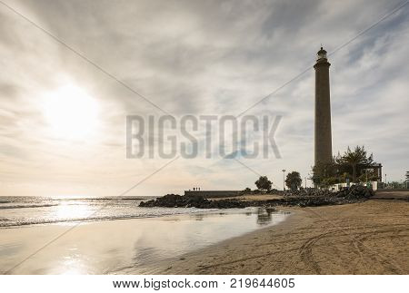 beautiful beach in Maspalomas, with Faro de Maspalomas, or Maspalomas lighthouse, in the background, Gran Canaria, Spain