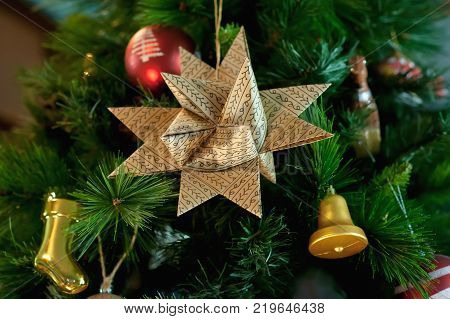 Paper, Christmas, six-pointed star on the branch of blue spruce, together with New Year's toys.