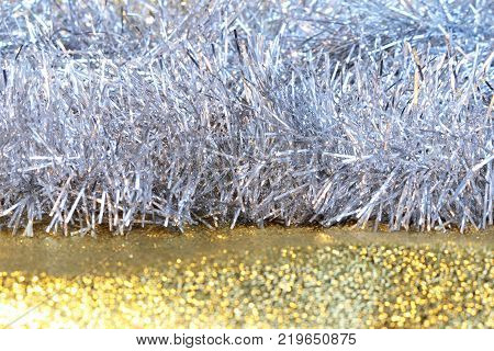 silver tinsel on a gold background for decorating a Christmas festive tree