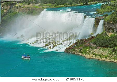 Niagara Falls from the US side Bride Veil Falls. Boat with tourists moves along Bride Veil Falls.