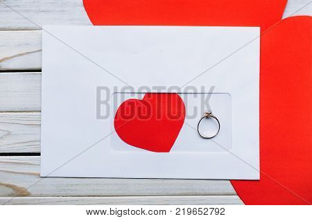 Envelope with a heart inside and a ring for a gift for St. Valentine's Day. Valentine's Day concept. Marriage proposal.