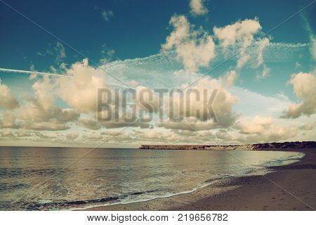 Beautiful sealandscape with dramatic clouds over blue sky and soft waves. Beauty world natural outdoors travel background