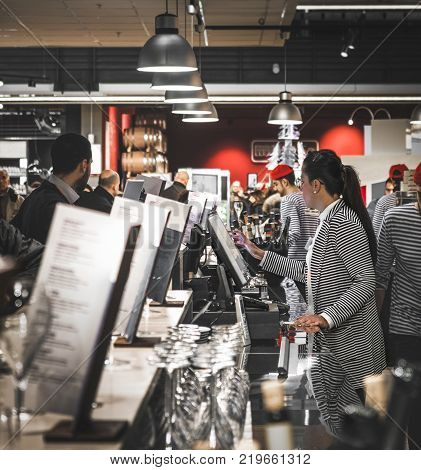 woman at the cash register takes orders and bills in an elegant restaurant at Fico Eataly World in Bologna, Italy, 08 Dec 2017