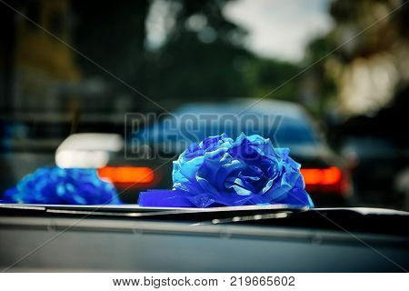 Close up wedding car decoration aftificial blue flower
