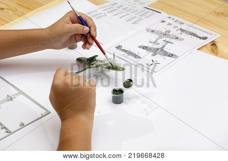 Boy Gluing Plastic Model Kit