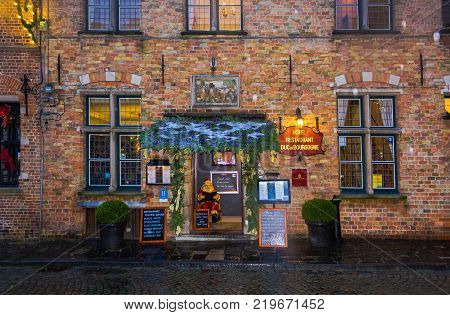 Bruges, Belgium - December 13, 2017: Old hotel restaurant Duc de Bourgogne in the historic center of Bruges, Belgium on December 13, 2017. The house in the traditional Belgian style.