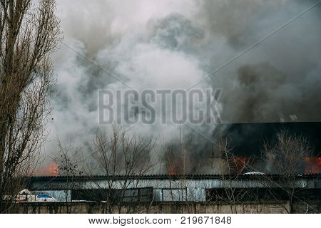 Fire in an industrial warehouse or Factory on Lantenskaya Street in Voronezh, rubber is burning, lots of smoke and flames, firefighters and MES rescue workers are struggling with a fire