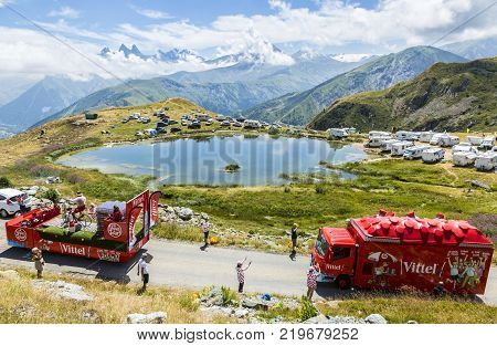 Col de la Croix de Fer France - 25 July 2015: Vittel caravan driving on the road to the Col de la Croix de Fer in Alps during the stage 20 of Le Tour de France 2015. Vittel is a French bottled water brand.