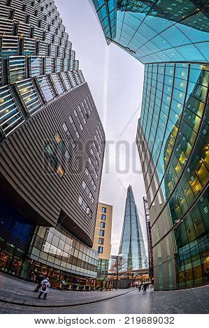 LONDON ENGLAND - NOVEMBER 27 2017: Modern and spectacular office buildings on More London Riversid and The Shard building in bachground.