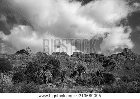 Mountains and cloudy sky in Gran Canaria, Canary Islands, Spain. Black and white photograph